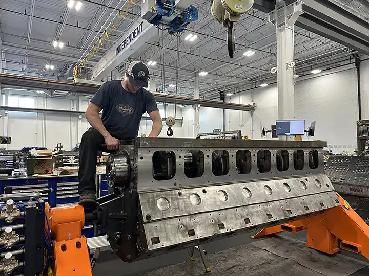 Independent Rebuild Specialist technician working on a CAT engine block during the in-house rebuild process.
